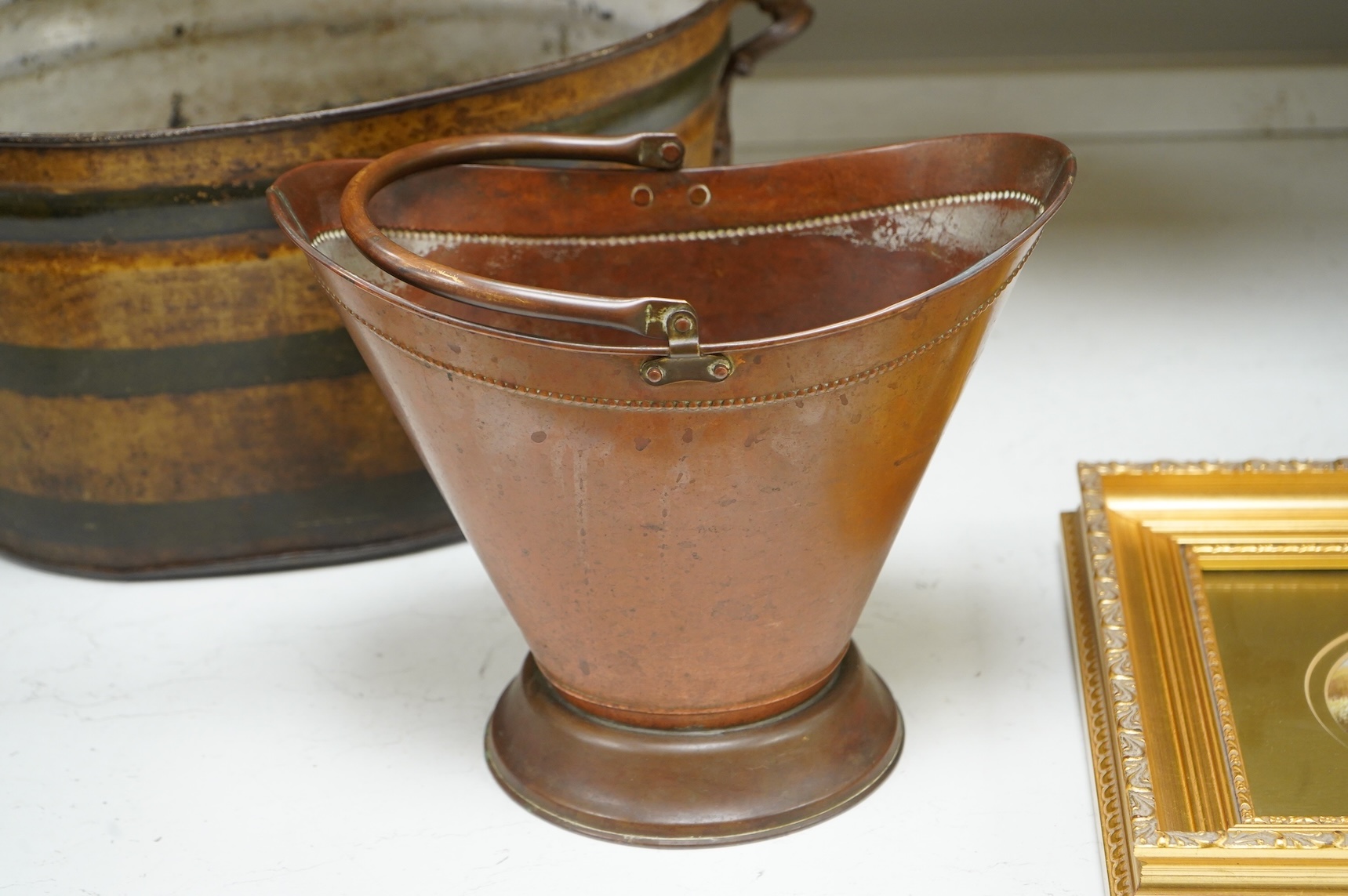 An oval toleware bin and another similar smaller bucket with swing handle, 48cm wide